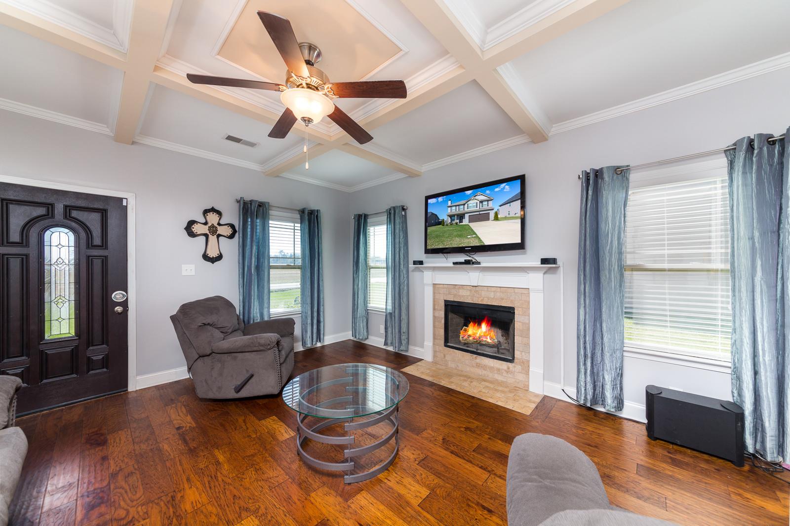 2340 Pea Ridge Road Clarksville, TN 37040 - Photo 6 of 25 a living room with furniture a fireplace and a flat screen tv