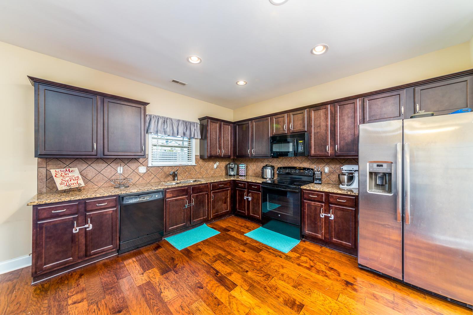 2340 Pea Ridge Road Clarksville, TN 37040 - Photo 9 of 25 a kitchen with stainless steel appliances granite countertop a stove refrigerator and sink