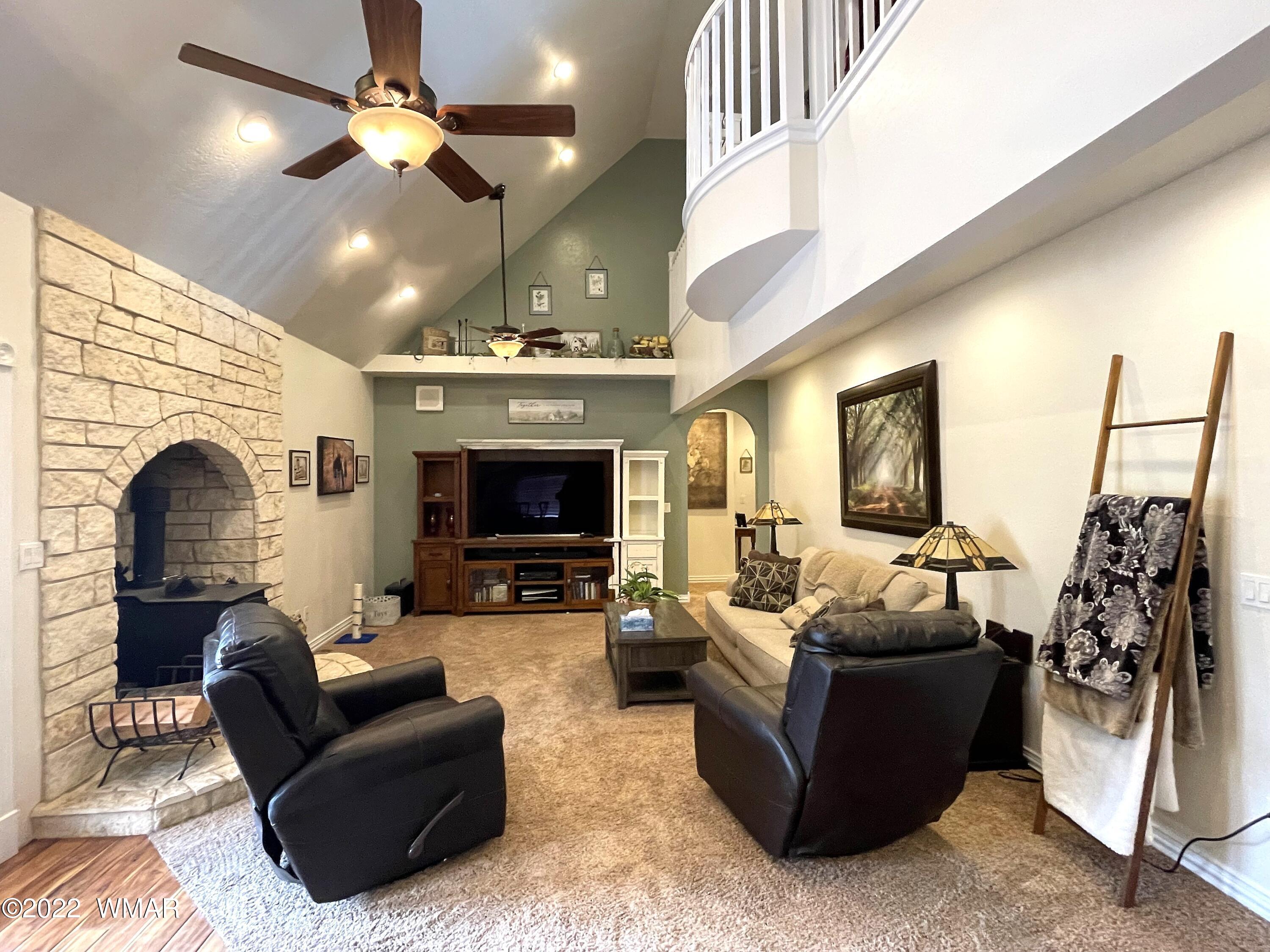 1713 Snowline Road Eagar, AZ 85925 - Photo 12 of 53 a living room with furniture a fireplace and a flat screen tv