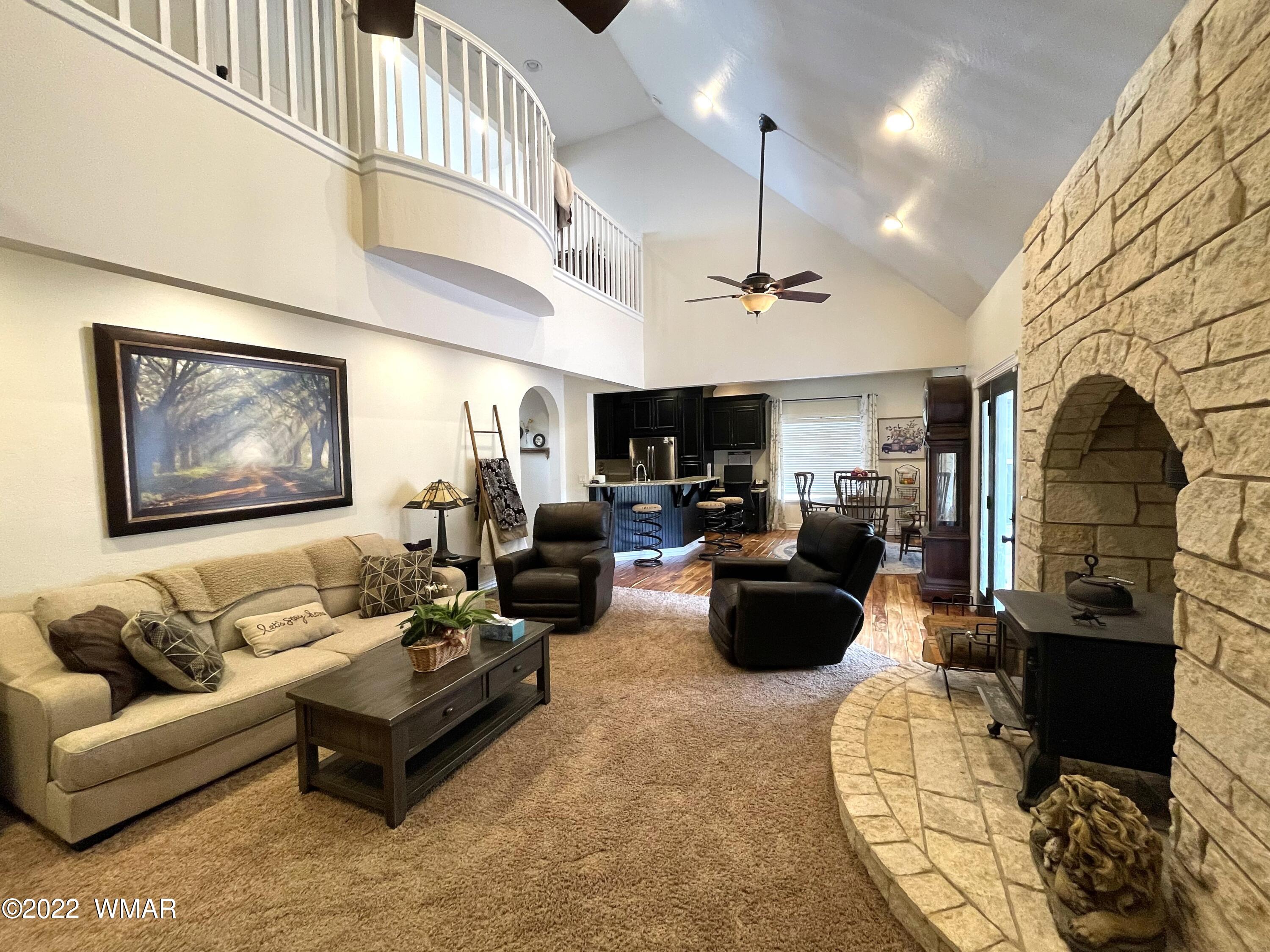 1713 Snowline Road Eagar, AZ 85925 - Photo 14 of 53 a living room with furniture ceiling fan and a rug