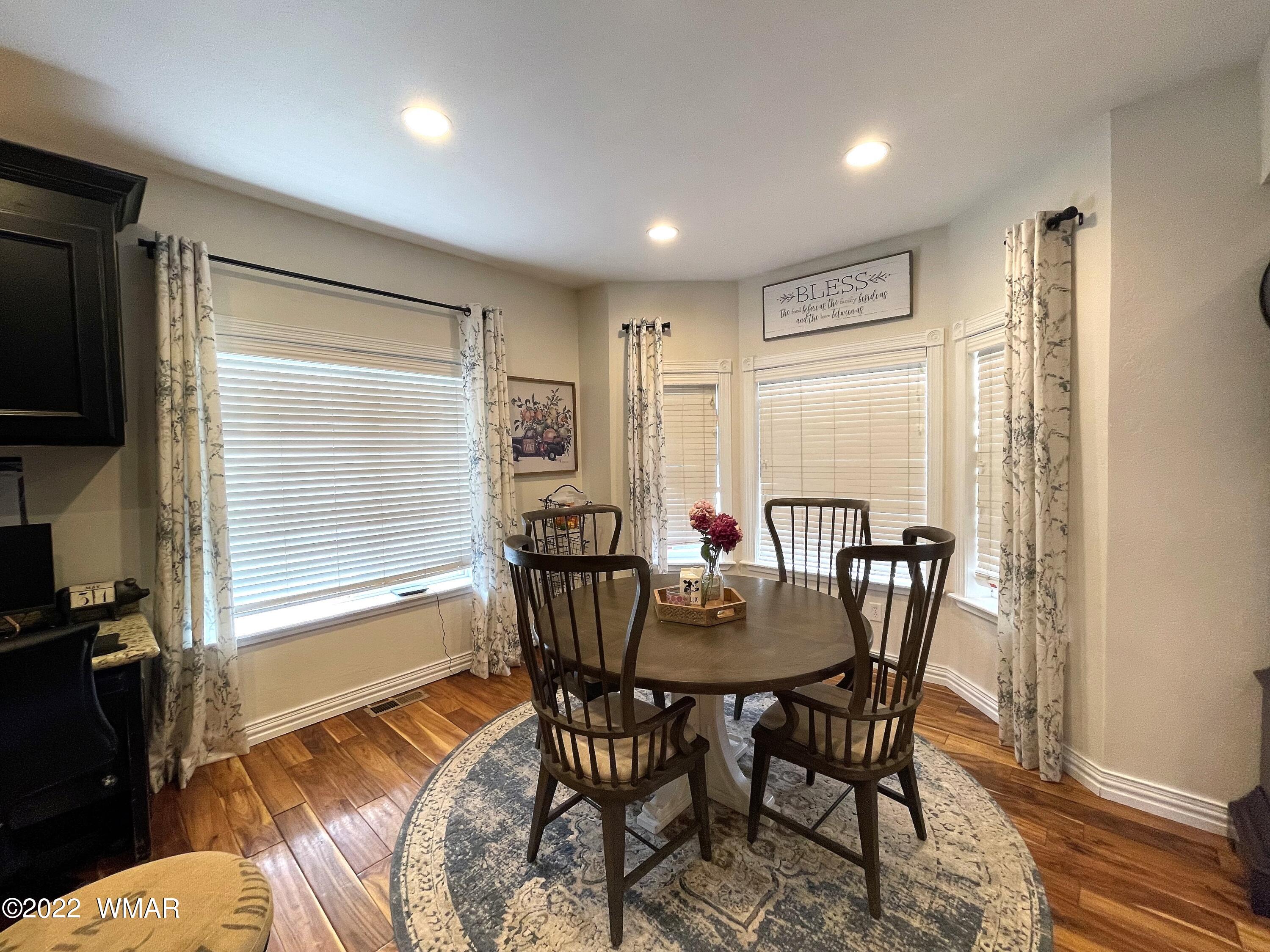 1713 Snowline Road Eagar, AZ 85925 - Photo 16 of 53 a view of a dining room with furniture window and wooden floor