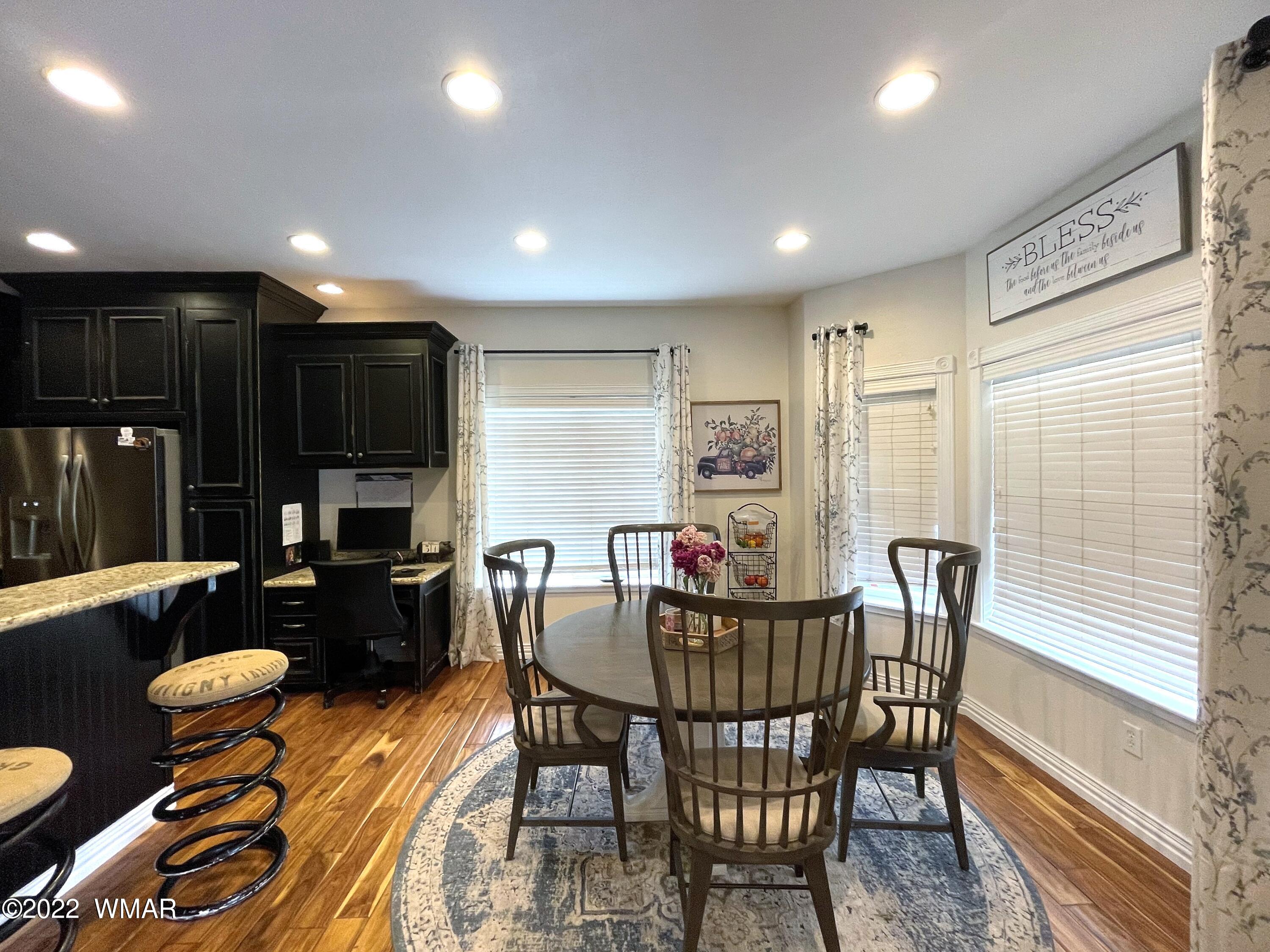 1713 Snowline Road Eagar, AZ 85925 - Photo 17 of 53 a dining room with furniture and a floor to ceiling window