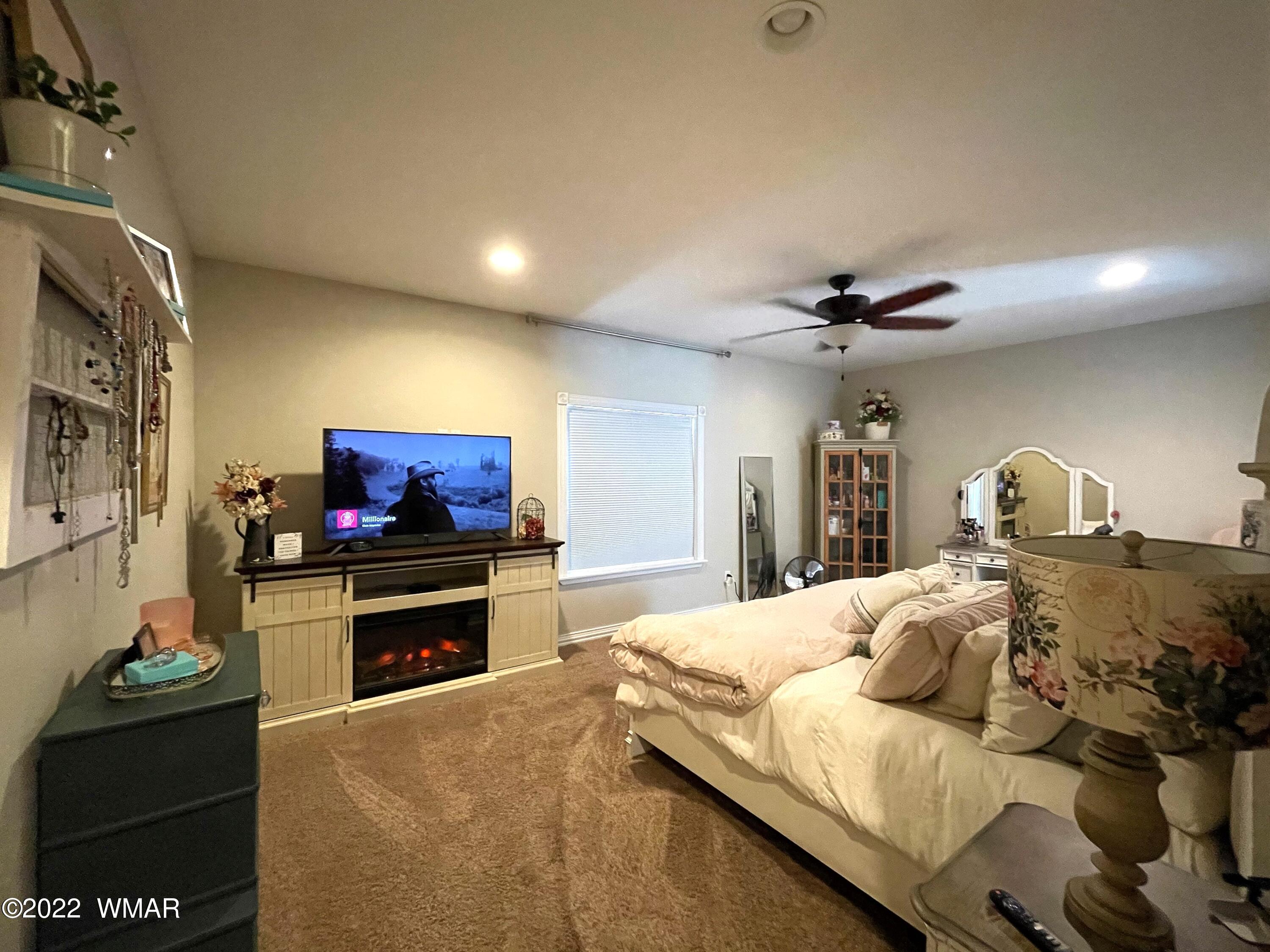 1713 Snowline Road Eagar, AZ 85925 - Photo 23 of 53 a bedroom with a bed and a television