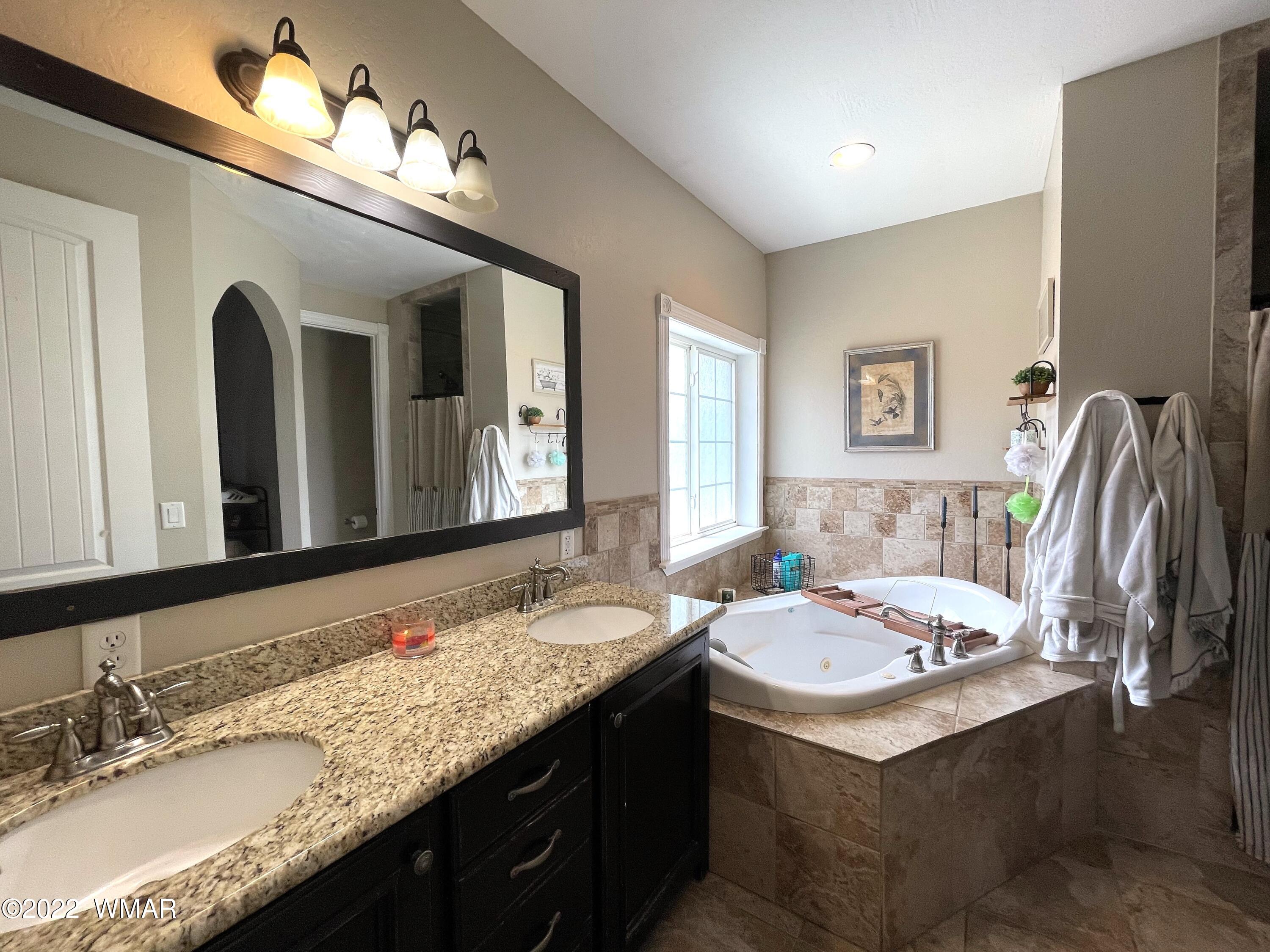 1713 Snowline Road Eagar, AZ 85925 - Photo 27 of 53 a bathroom with a sink double vanity and a mirror