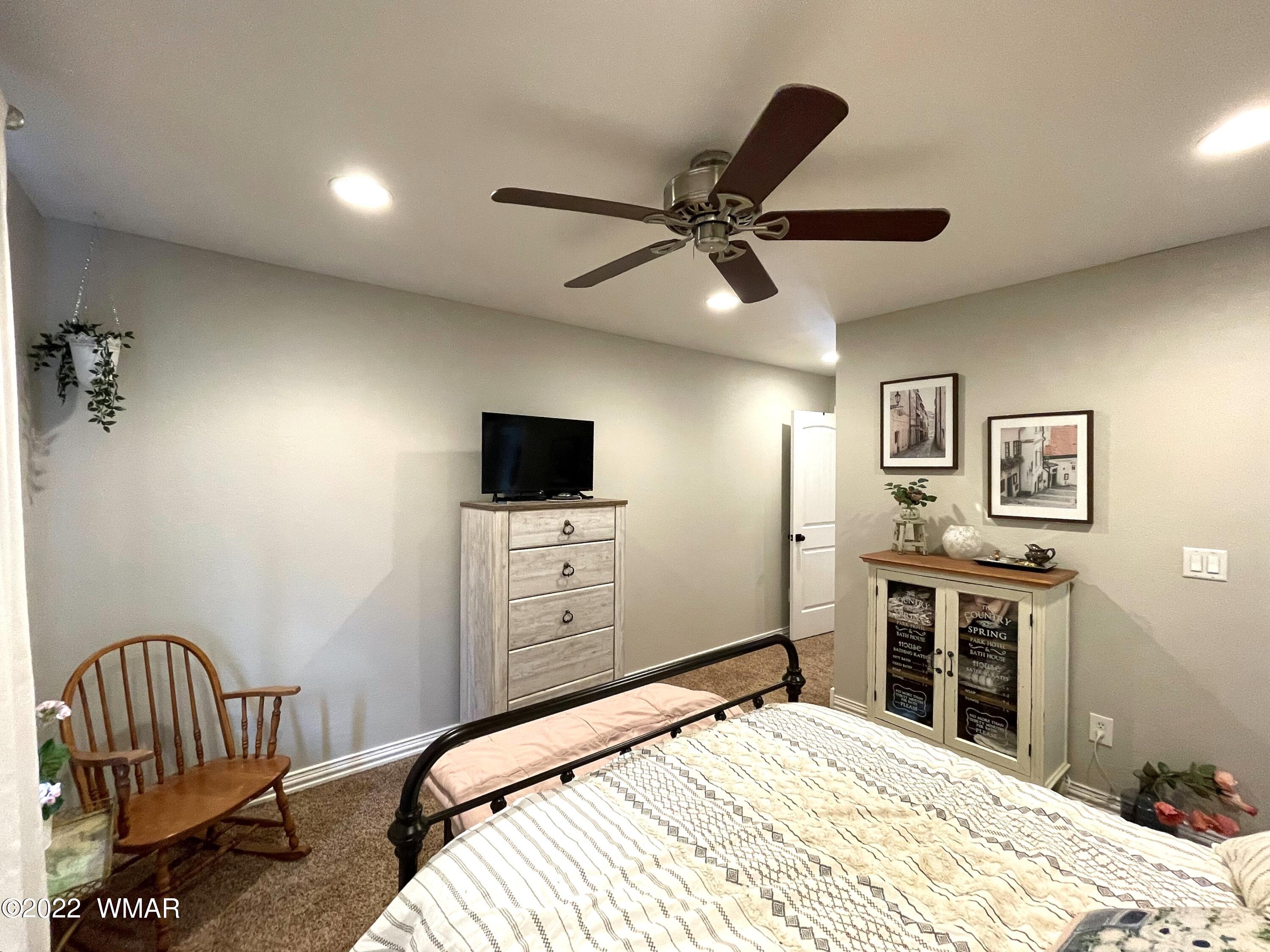 1713 Snowline Road Eagar, AZ 85925 - Photo 37 of 53 a bedroom with a bed and a tv