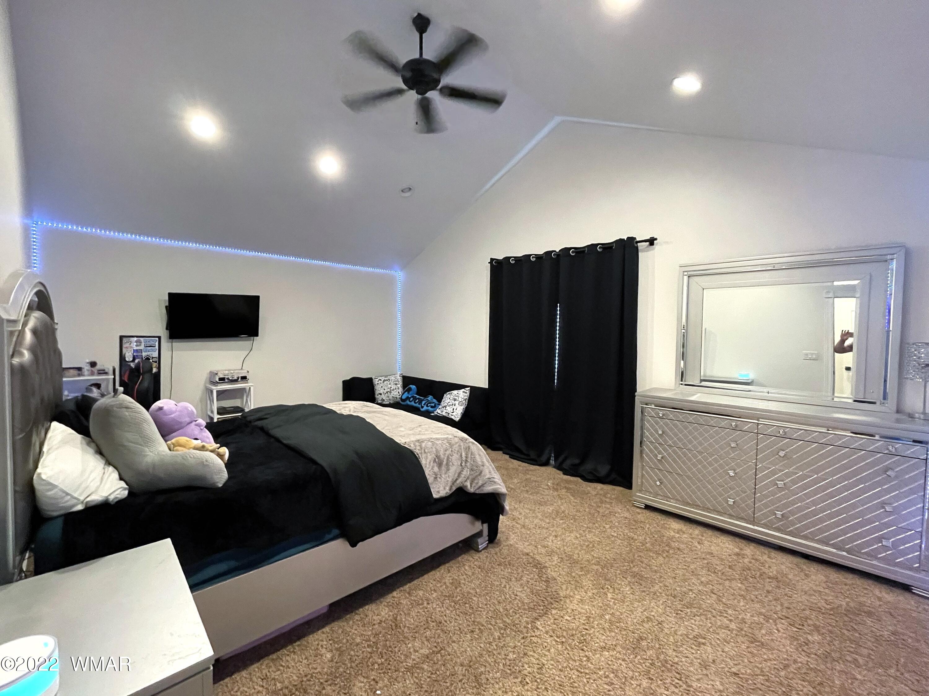 1713 Snowline Road Eagar, AZ 85925 - Photo 39 of 53 a bedroom with a bed and a flat screen tv
