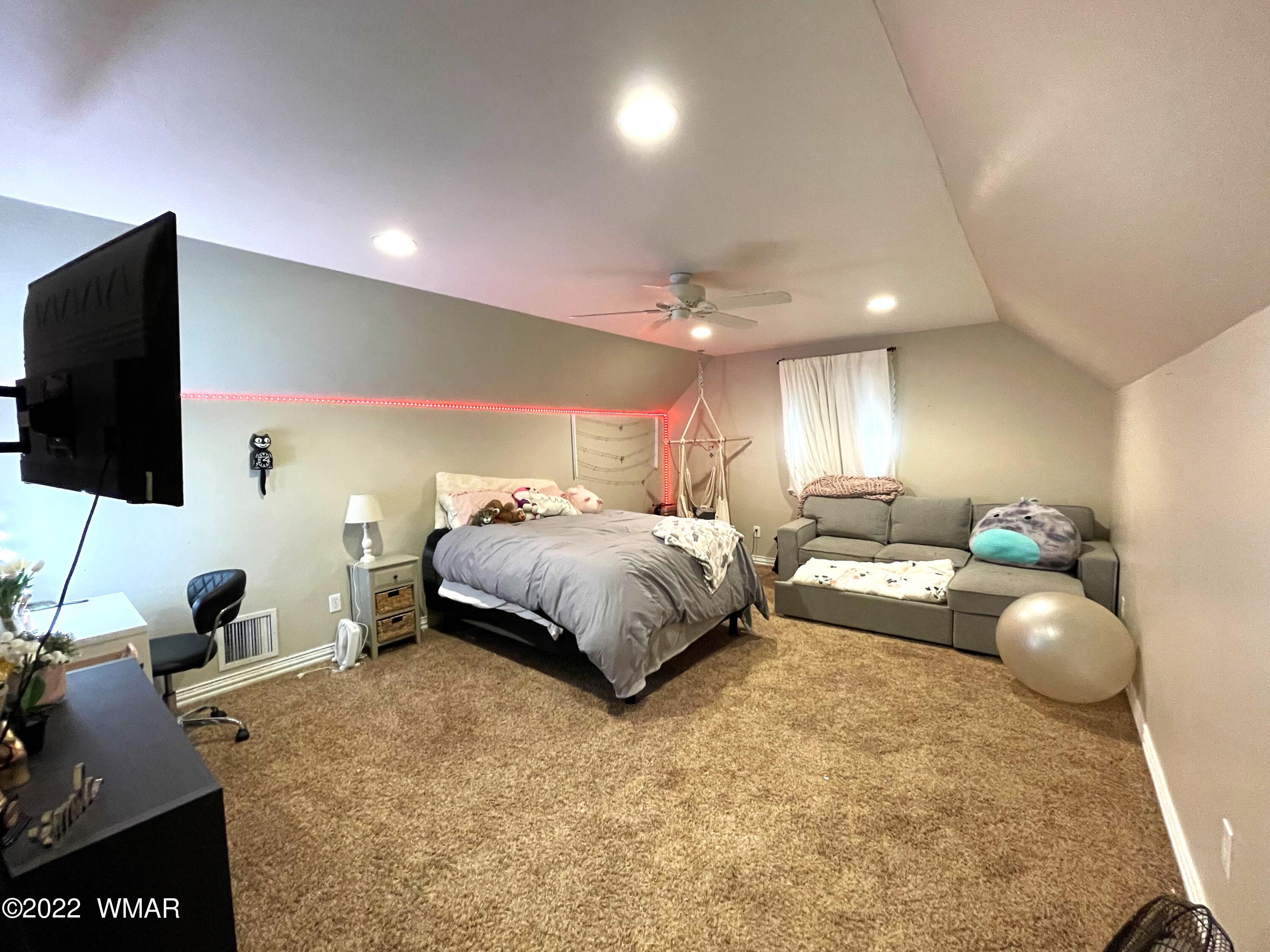 1713 Snowline Road Eagar, AZ 85925 - Photo 42 of 53 a bedroom with a bed and flat screen tv