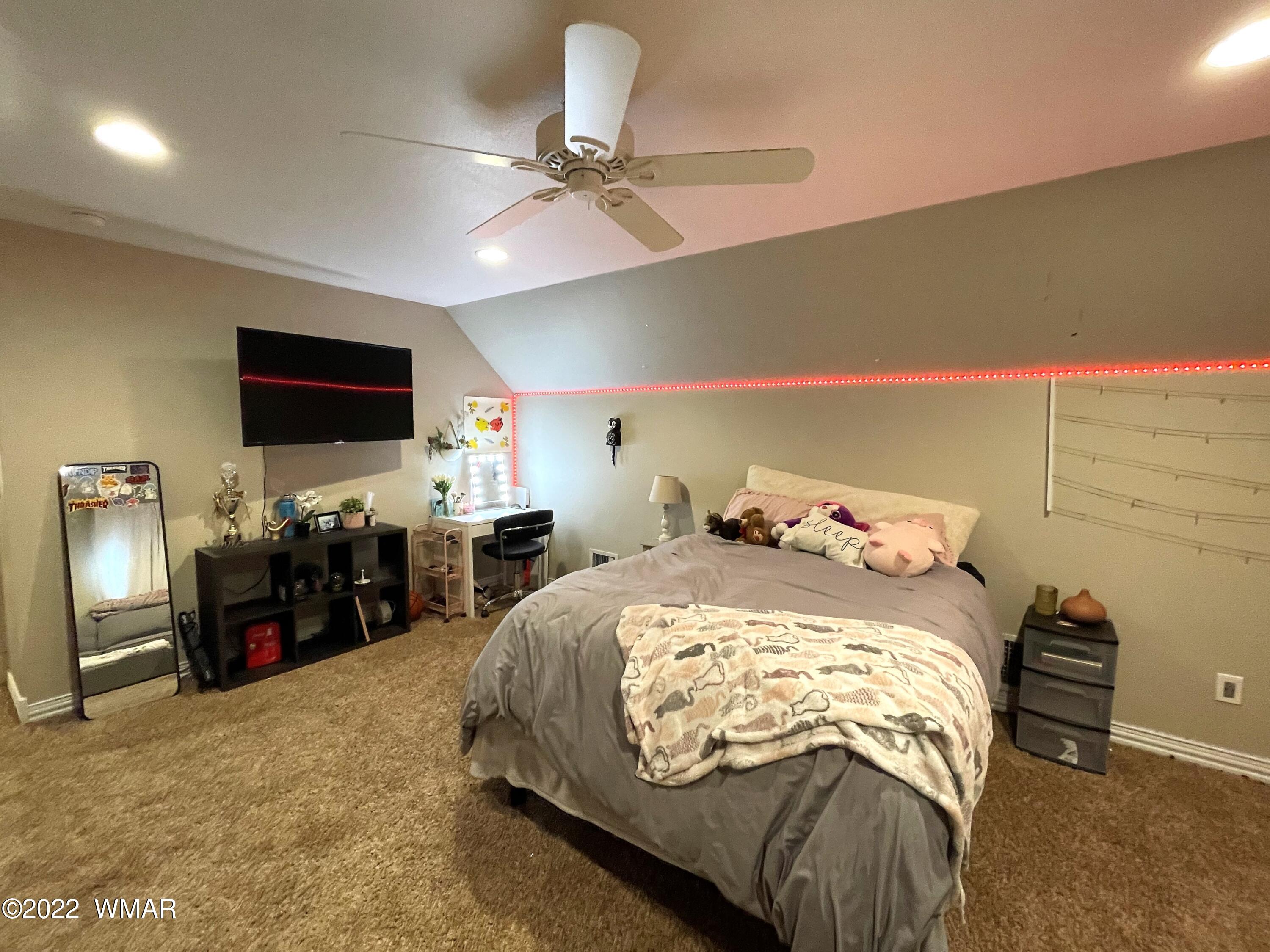 1713 Snowline Road Eagar, AZ 85925 - Photo 43 of 53 a bed room with a bed and a flat screen tv