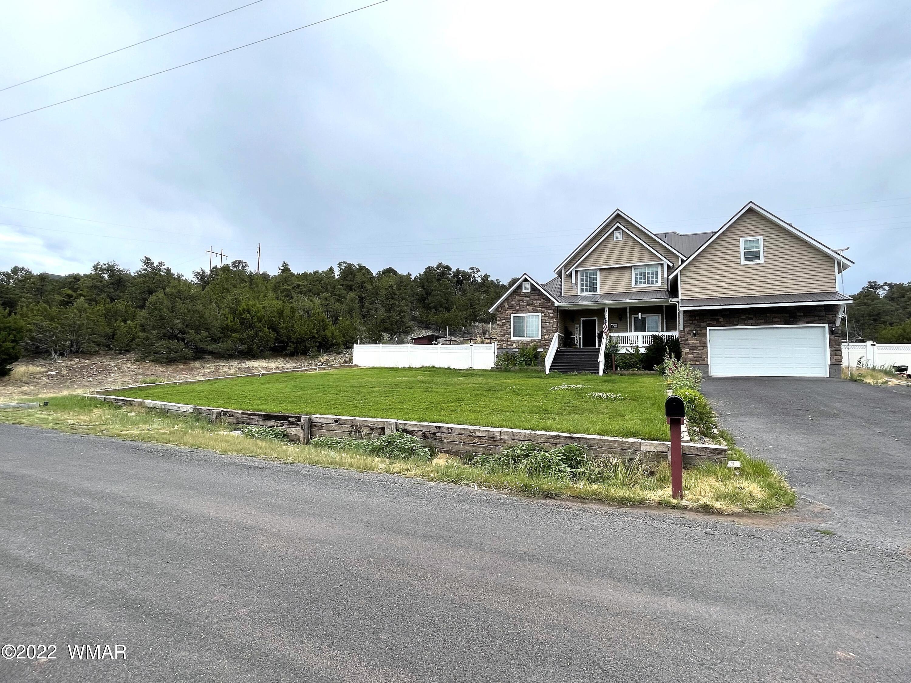 1713 Snowline Road Eagar, AZ 85925 - Photo 52 of 53 a front view of a house with a yard