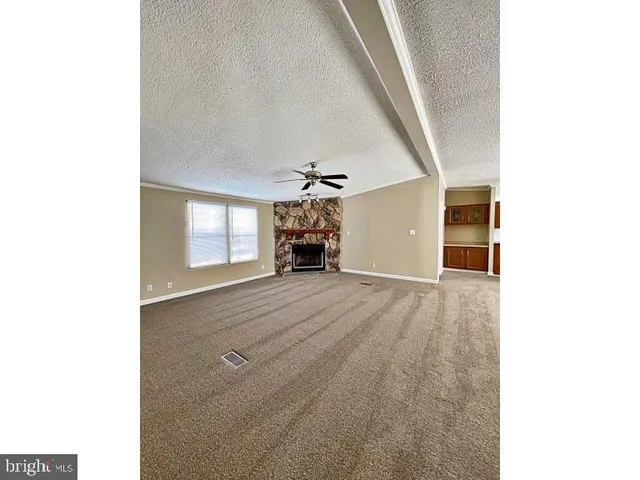 a view of a livingroom with furniture and a window