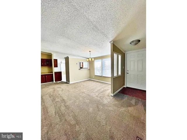 a view of an empty room with closet