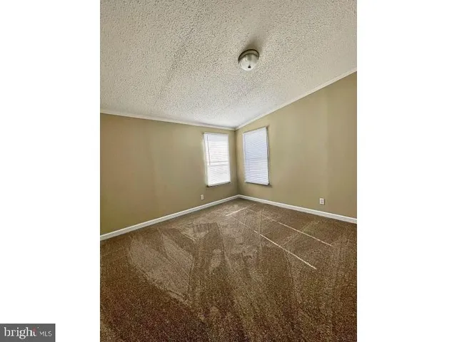 a view of an empty room with windows