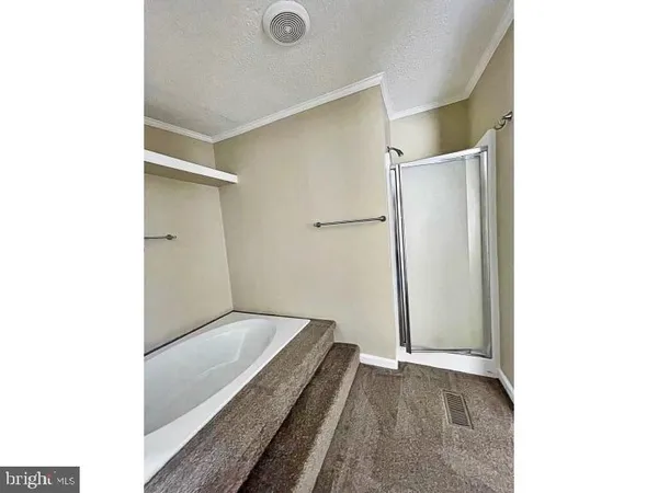 a view of a hallway with a bathroom