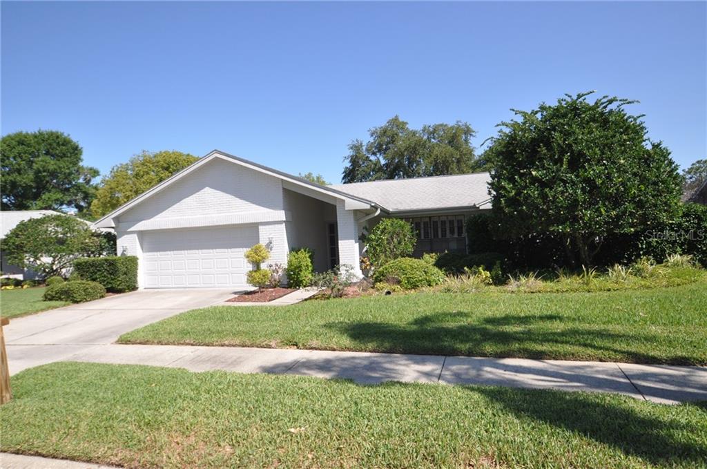 9849 Stephenson Drive New Port Richey, FL 34655 - Photo 1 of 1 a front view of a house with a yard and garage