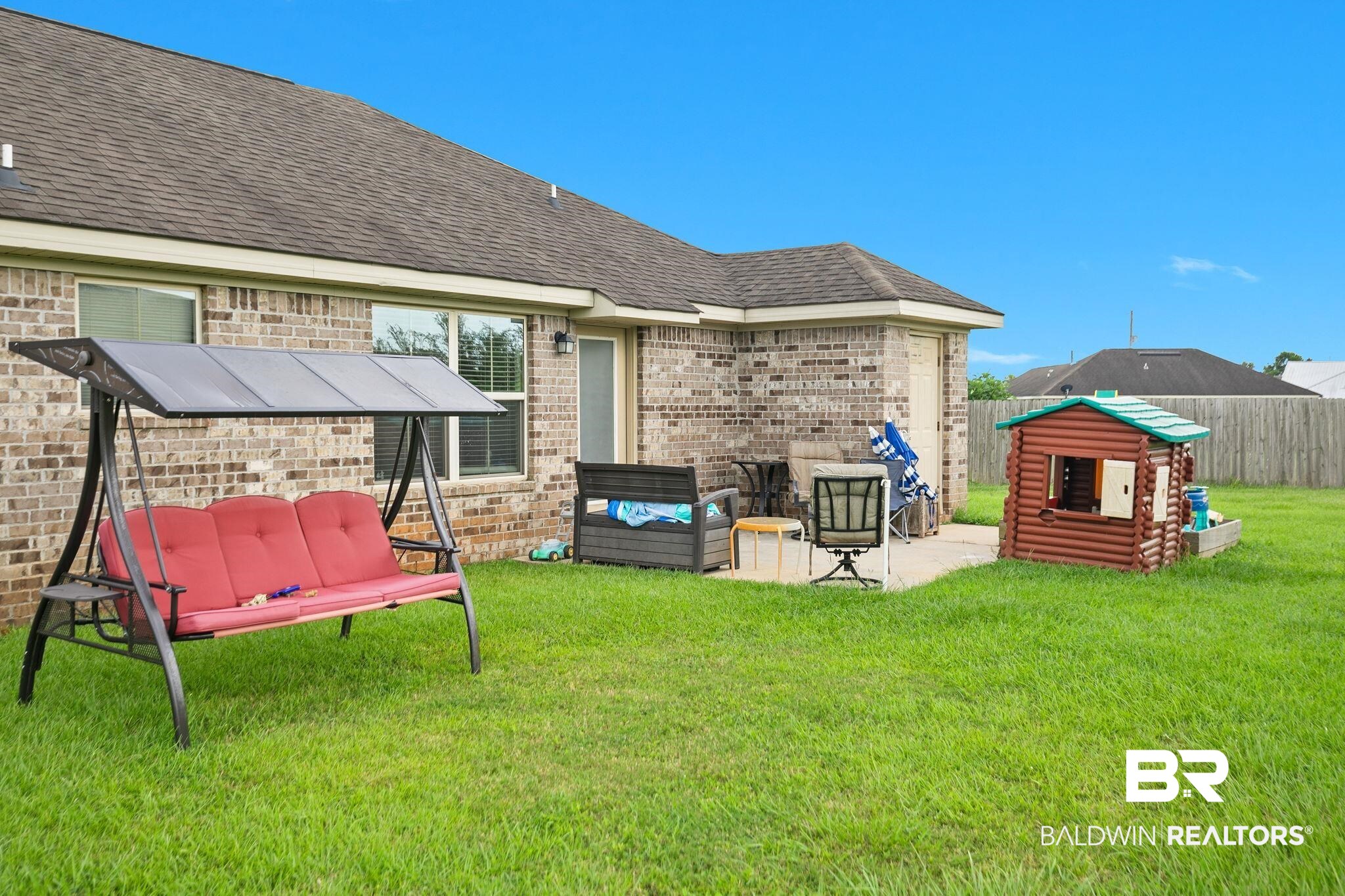 15573 Talus Court Foley, AL 36535 - Photo 37 of 50 Rear view of house featuring a patio and a lawn