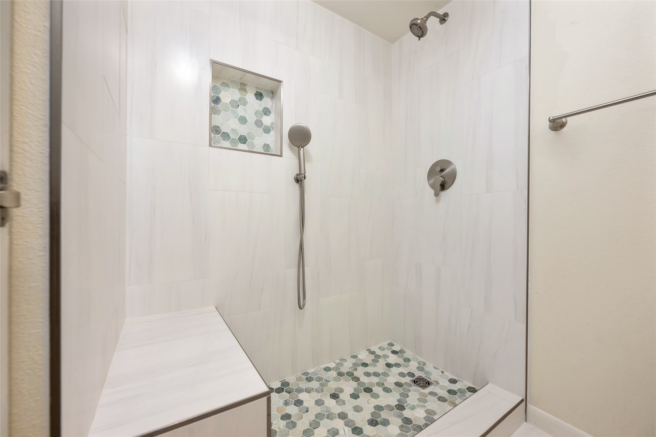 5319 Musket Ridge Austin, TX 78759 - Photo 29 of 39 Step into a meticulously designed shower with a tiled bench and a striking hexagonal mosaic floor.