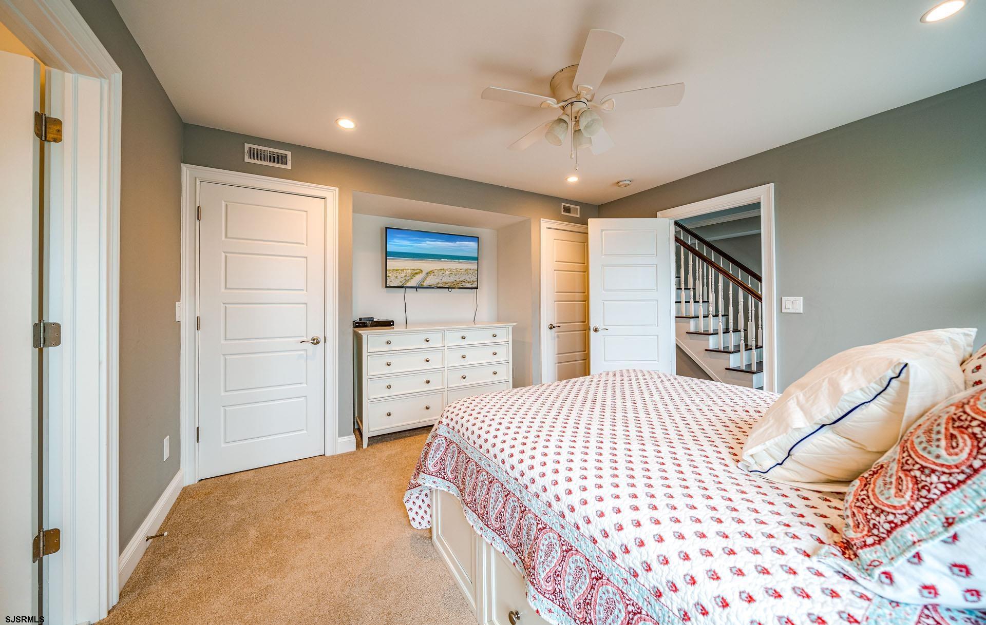 84 East Station Road Ocean City, NJ 08226 - Photo 12 of 30 a bedroom with a bed and a walk in closet