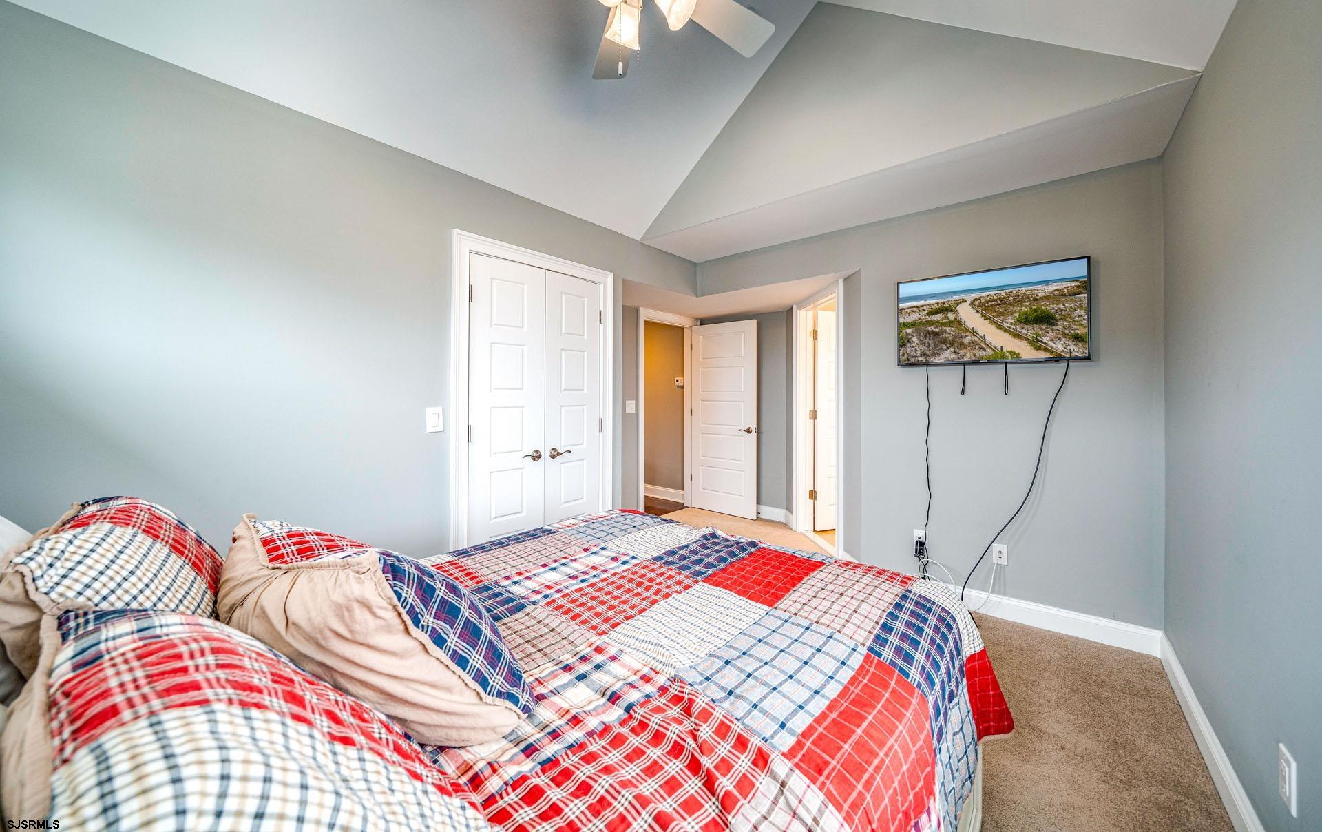 84 East Station Road Ocean City, NJ 08226 - Photo 16 of 30 a bedroom with a bed and a painting on the wall