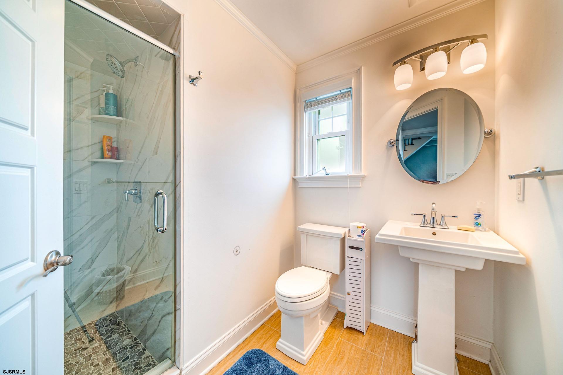 84 East Station Road Ocean City, NJ 08226 - Photo 17 of 30 a bathroom with a toilet sink and mirror