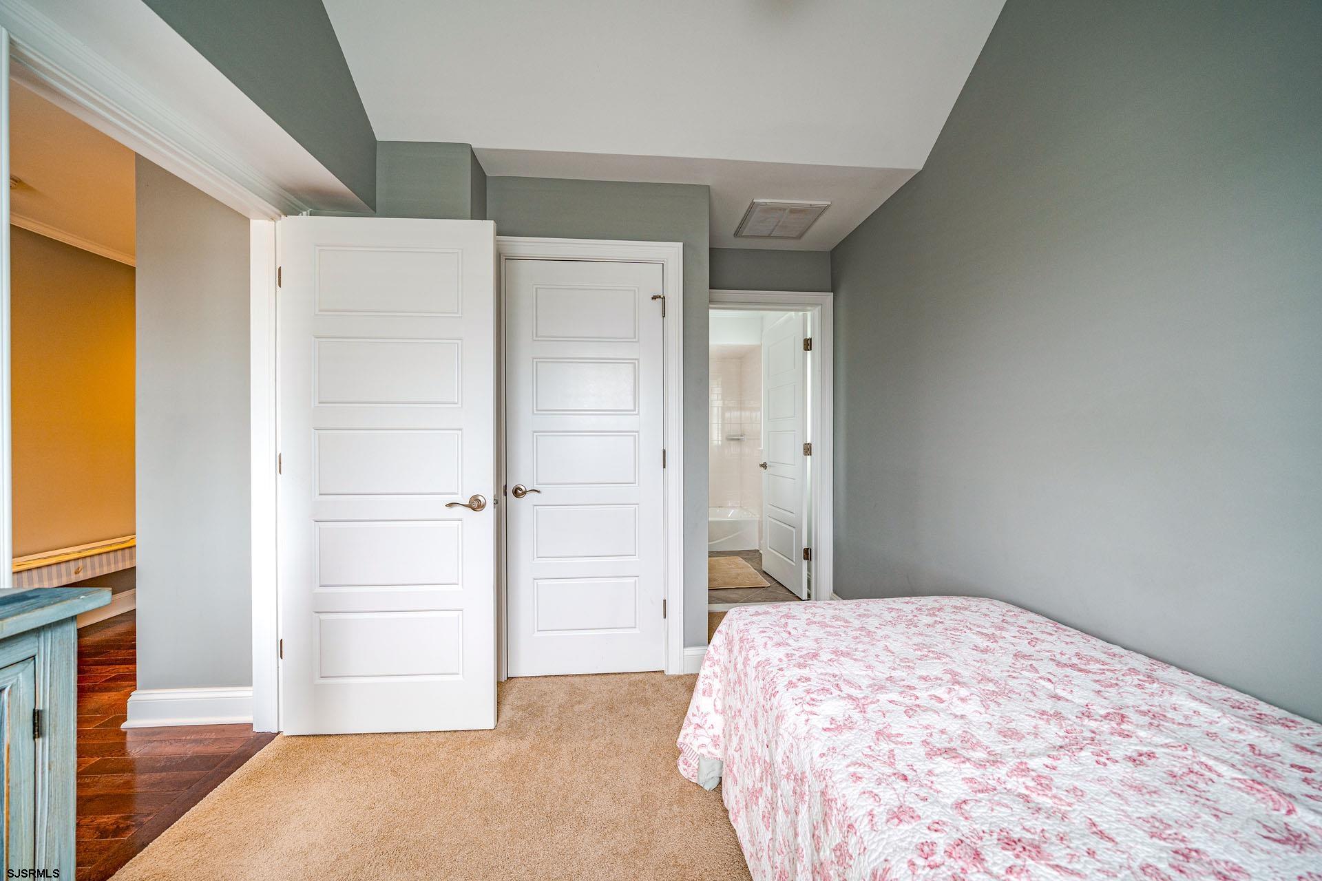 84 East Station Road Ocean City, NJ 08226 - Photo 19 of 30 a bedroom with a bed and a hallway