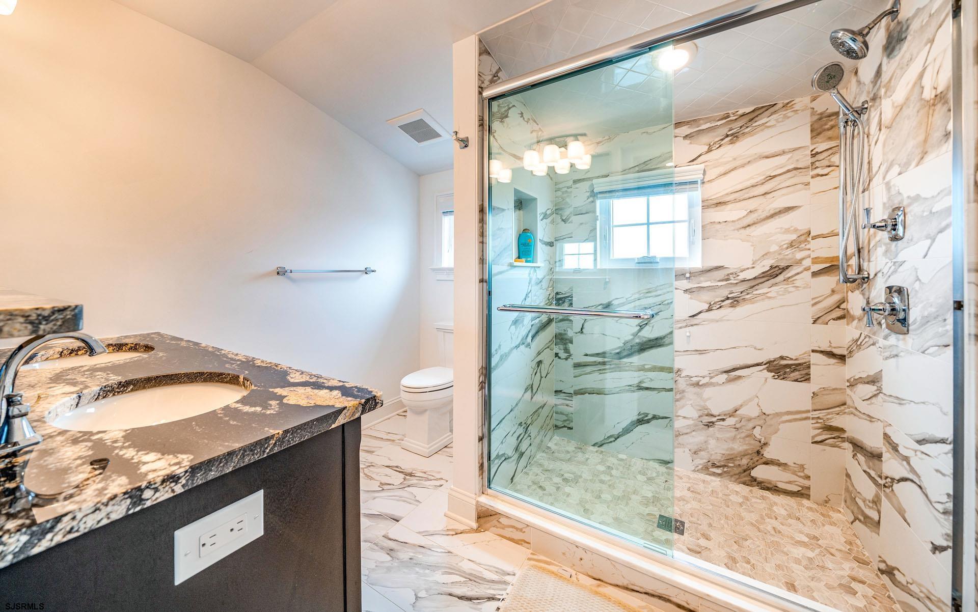 84 East Station Road Ocean City, NJ 08226 - Photo 25 of 30 a bathroom with a granite countertop sink and a mirror