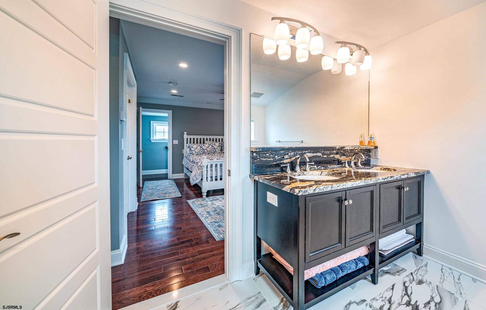 84 East Station Road Ocean City, NJ 08226 - Photo 26 of 30 a kitchen with a stove and a wooden floor