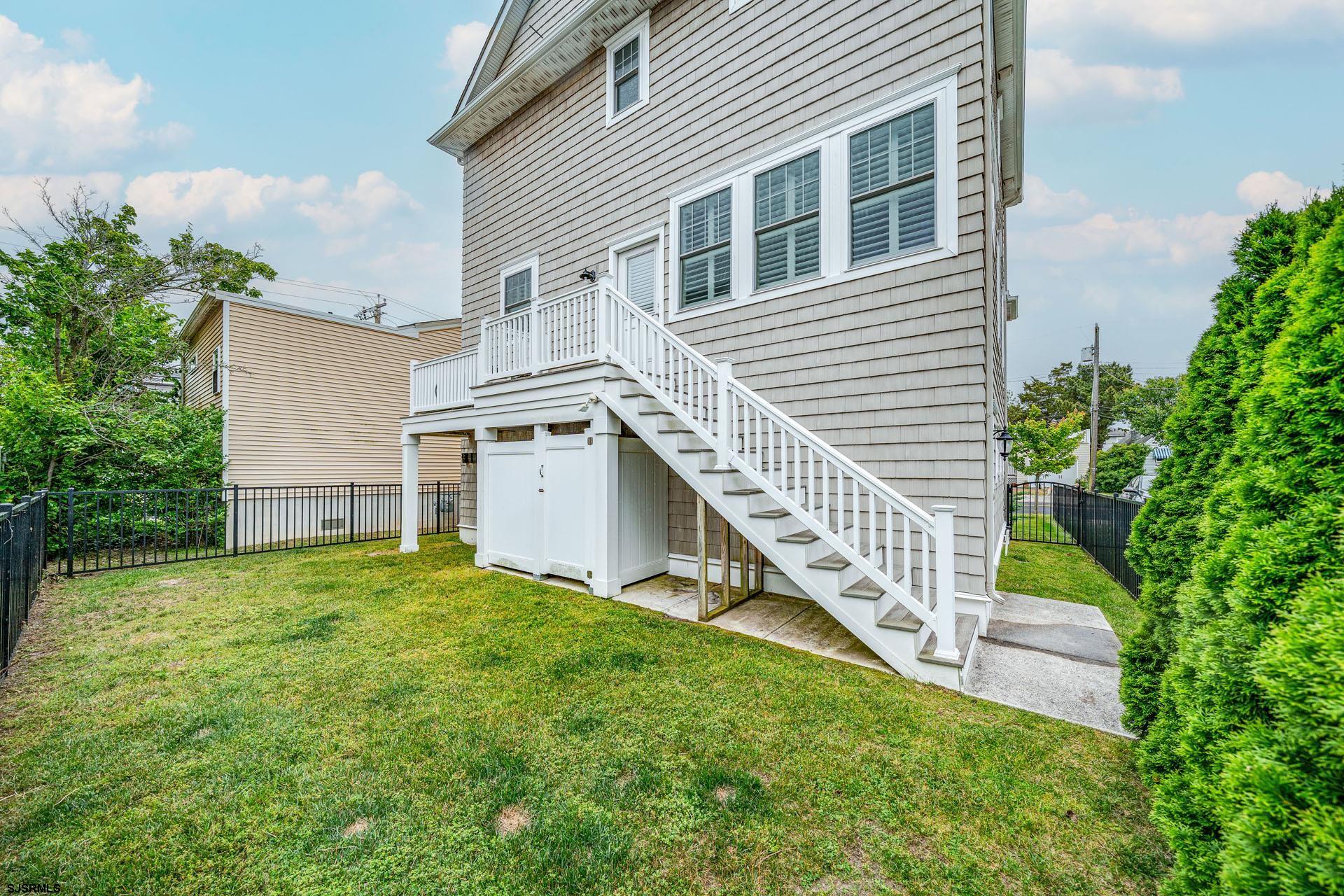 84 East Station Road Ocean City, NJ 08226 - Photo 30 of 30 a view of a house with a yard and a wooden deck