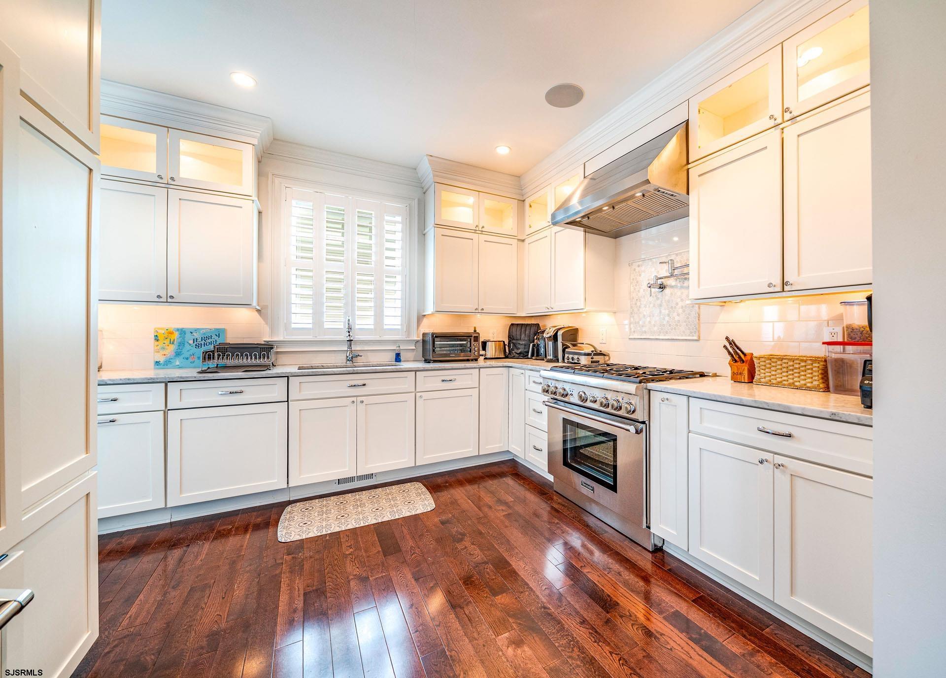 84 East Station Road Ocean City, NJ 08226 - Photo 6 of 30 a kitchen with granite countertop white cabinets and white appliances