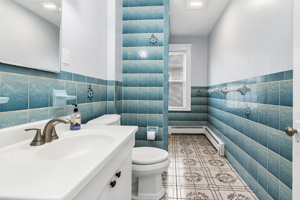 32-34 Magnolia Street, Unit 2 Lawrence, MA 01841 - Photo 11 of 29 a bathroom with a sink toilet and shower