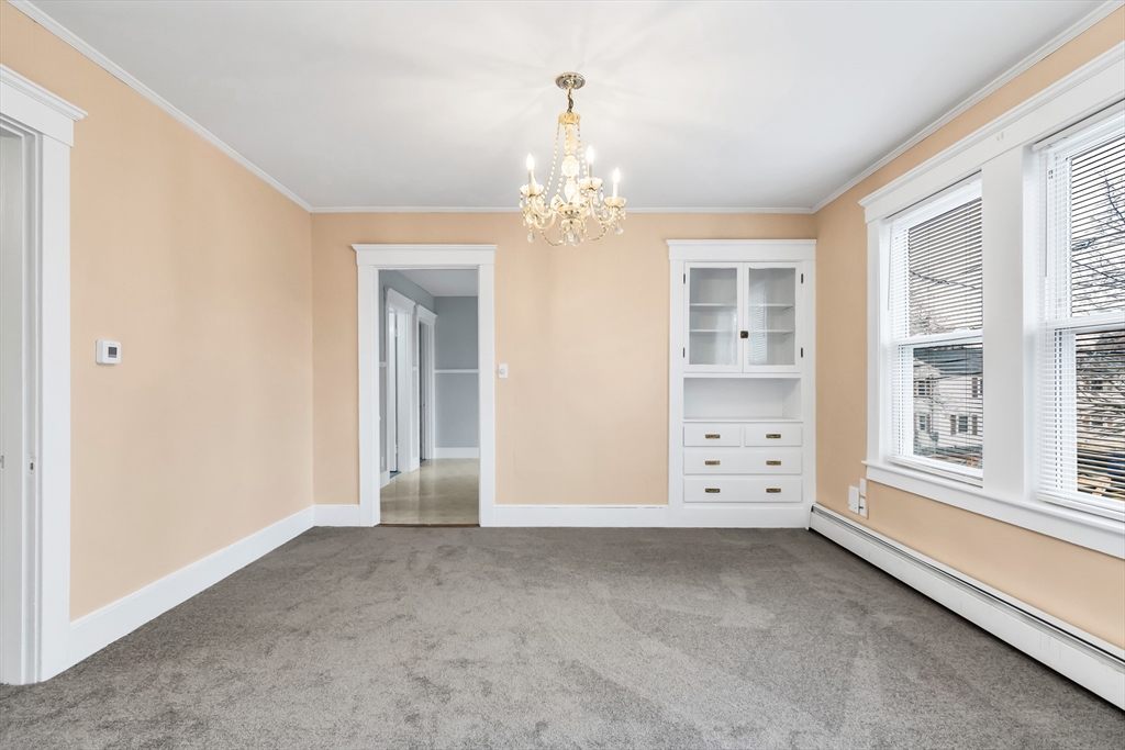32-34 Magnolia Street, Unit 2 Lawrence, MA 01841 - Photo 15 of 29 an empty room with windows and entrance