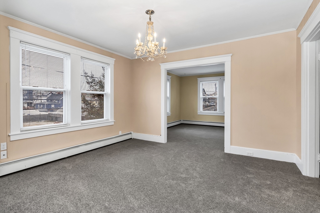 32-34 Magnolia Street, Unit 2 Lawrence, MA 01841 - Photo 16 of 29 a view of a big room with windows and chandelier