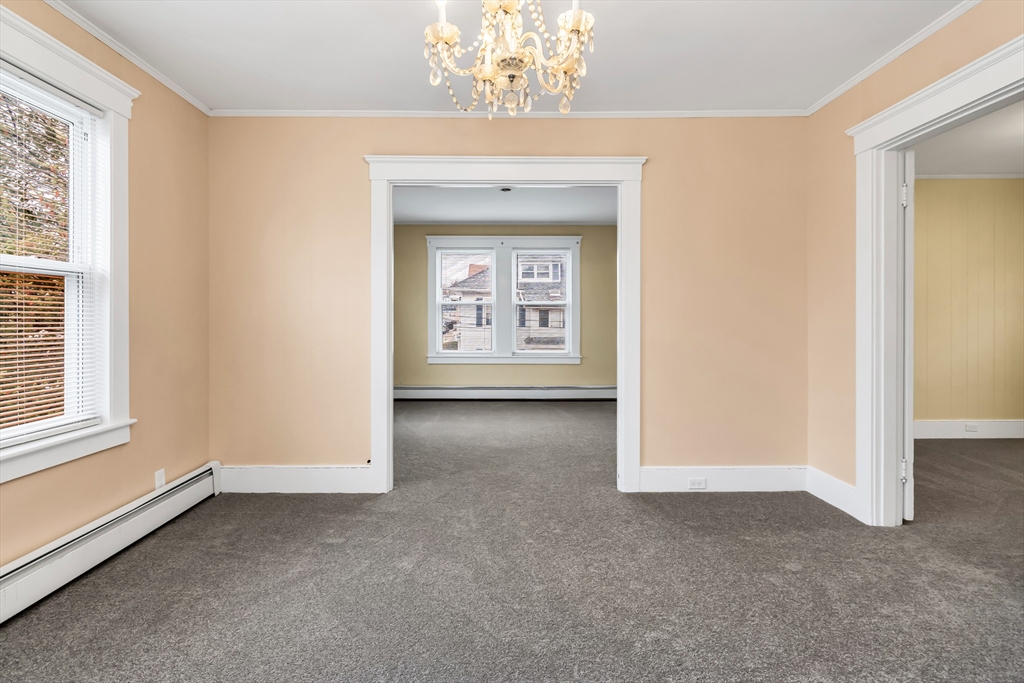 32-34 Magnolia Street, Unit 2 Lawrence, MA 01841 - Photo 17 of 29 an empty room with windows and entrance