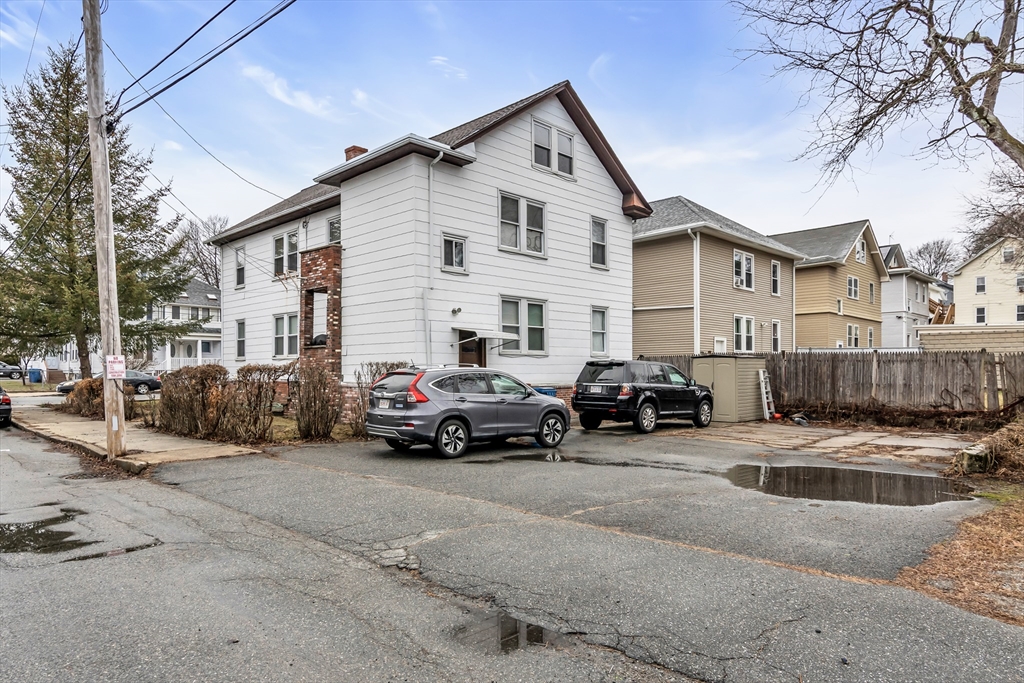 32-34 Magnolia Street, Unit 2 Lawrence, MA 01841 - Photo 29 of 29 a view of a cars park in front of a house