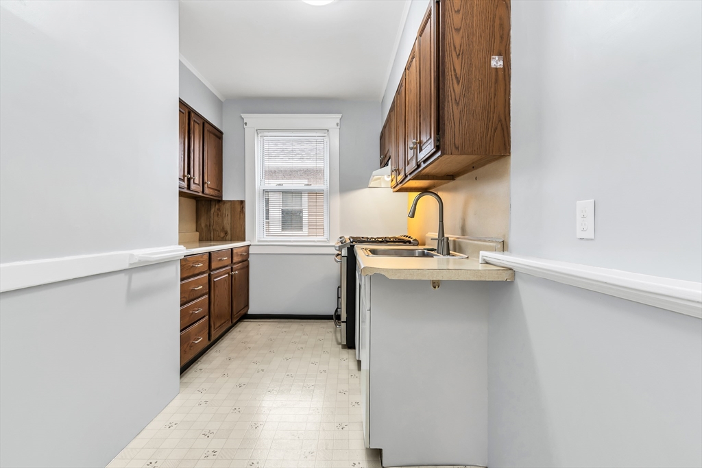 32-34 Magnolia Street, Unit 2 Lawrence, MA 01841 - Photo 7 of 29 a kitchen with stainless steel appliances a sink and a stove