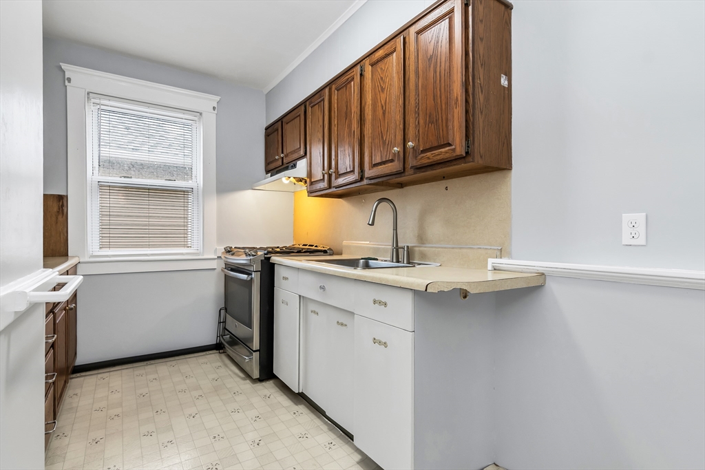 32-34 Magnolia Street, Unit 2 Lawrence, MA 01841 - Photo 8 of 29 a kitchen with a sink cabinets and window