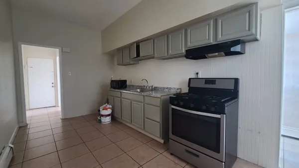 a kitchen with stainless steel appliances granite countertop a stove and a microwave