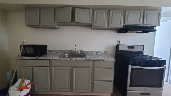 a kitchen with a stove and cabinets