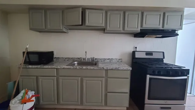 a kitchen with a stove and cabinets
