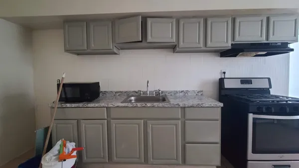 a kitchen with stainless steel appliances granite countertop a sink dishwasher a stove and a microwave oven on granite countertops