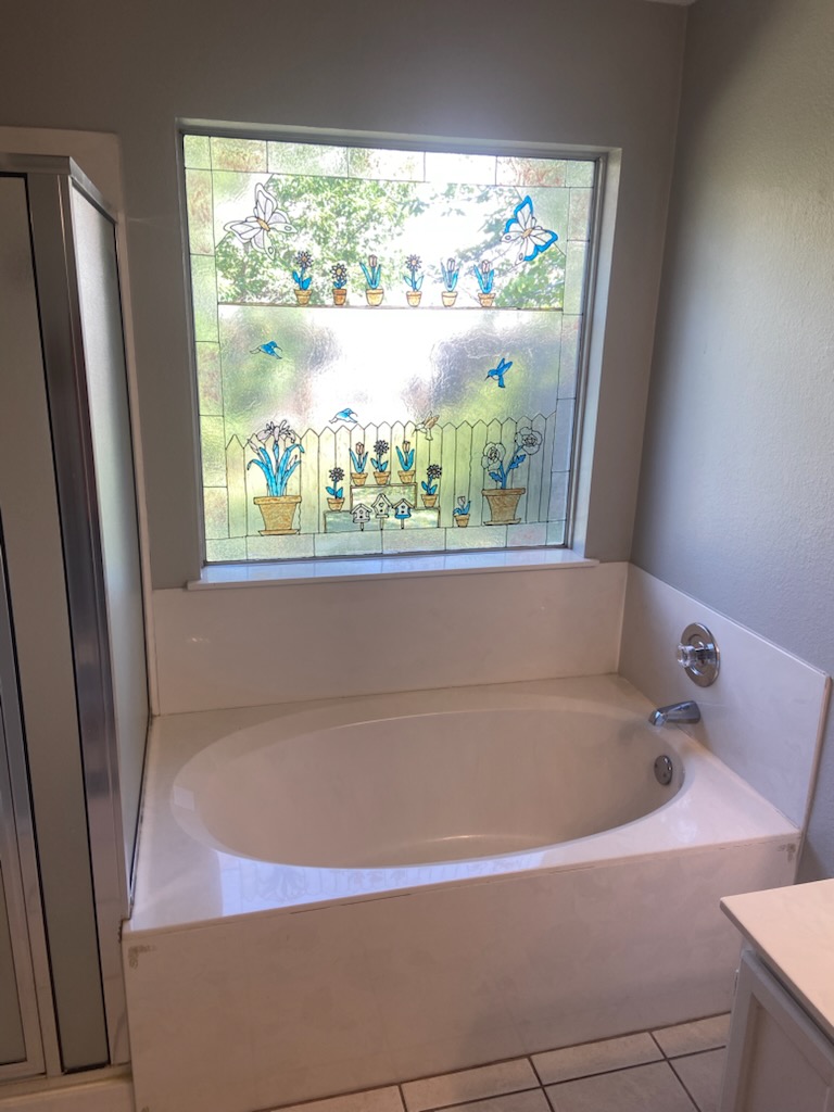 17616 Tobermory Drive Pflugerville, TX 78660 - Photo 7 of 14 Relax in this inviting tub, illuminated by a charming window featuring decorative glass.