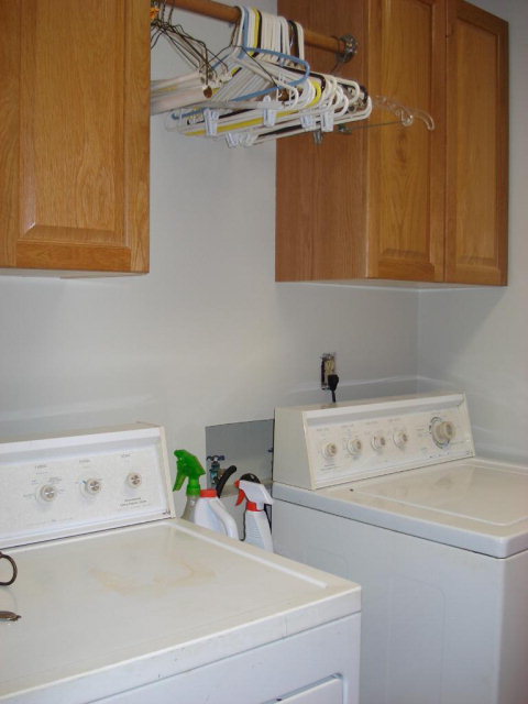 7573 Heritage Road Spring Hope, NC 27882 - Photo 14 of 21 Laundry room has wall cabinets and rod to hang clothes.