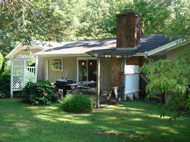 7573 Heritage Road Spring Hope, NC 27882 - Photo 4 of 21 Concrete patio just off den/kitchen area. Lots of flowering plants .