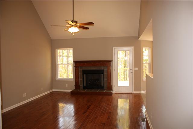 1331 Campbell Ridge Road Kingston Springs, TN 37082 - Photo 2 of 16 a view of an empty room with wooden floor fireplace and a window