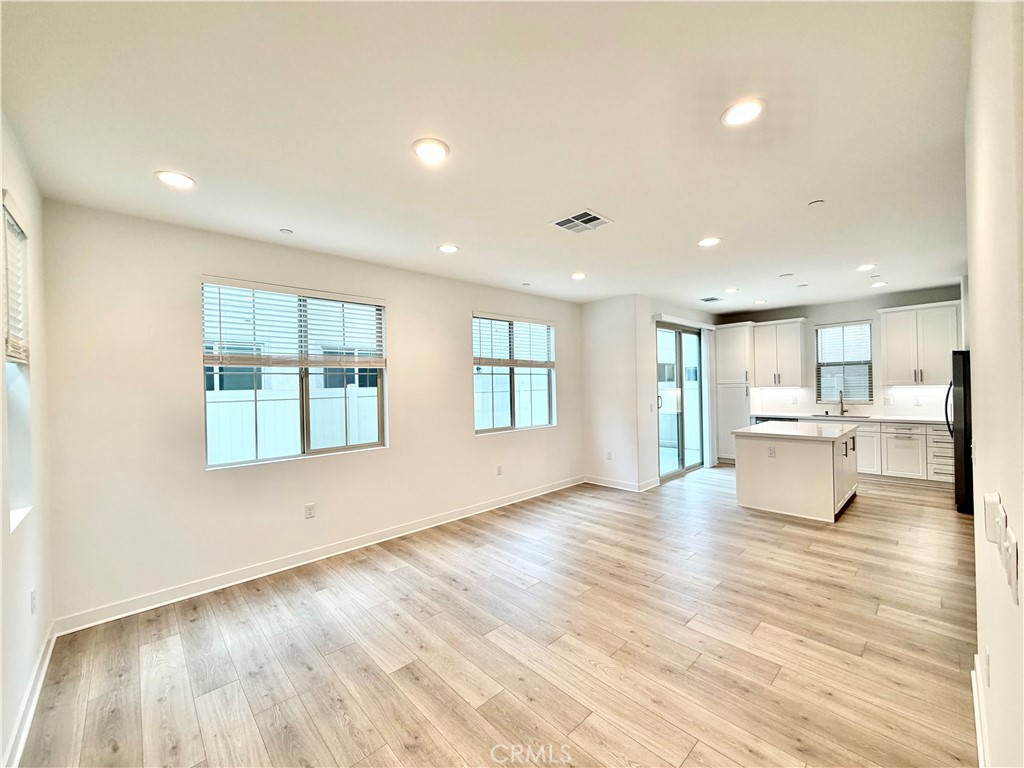 26893 Rubicon Road Menifee, CA 92586 - Photo 5 of 32 a view of an empty room with wooden floor and a window