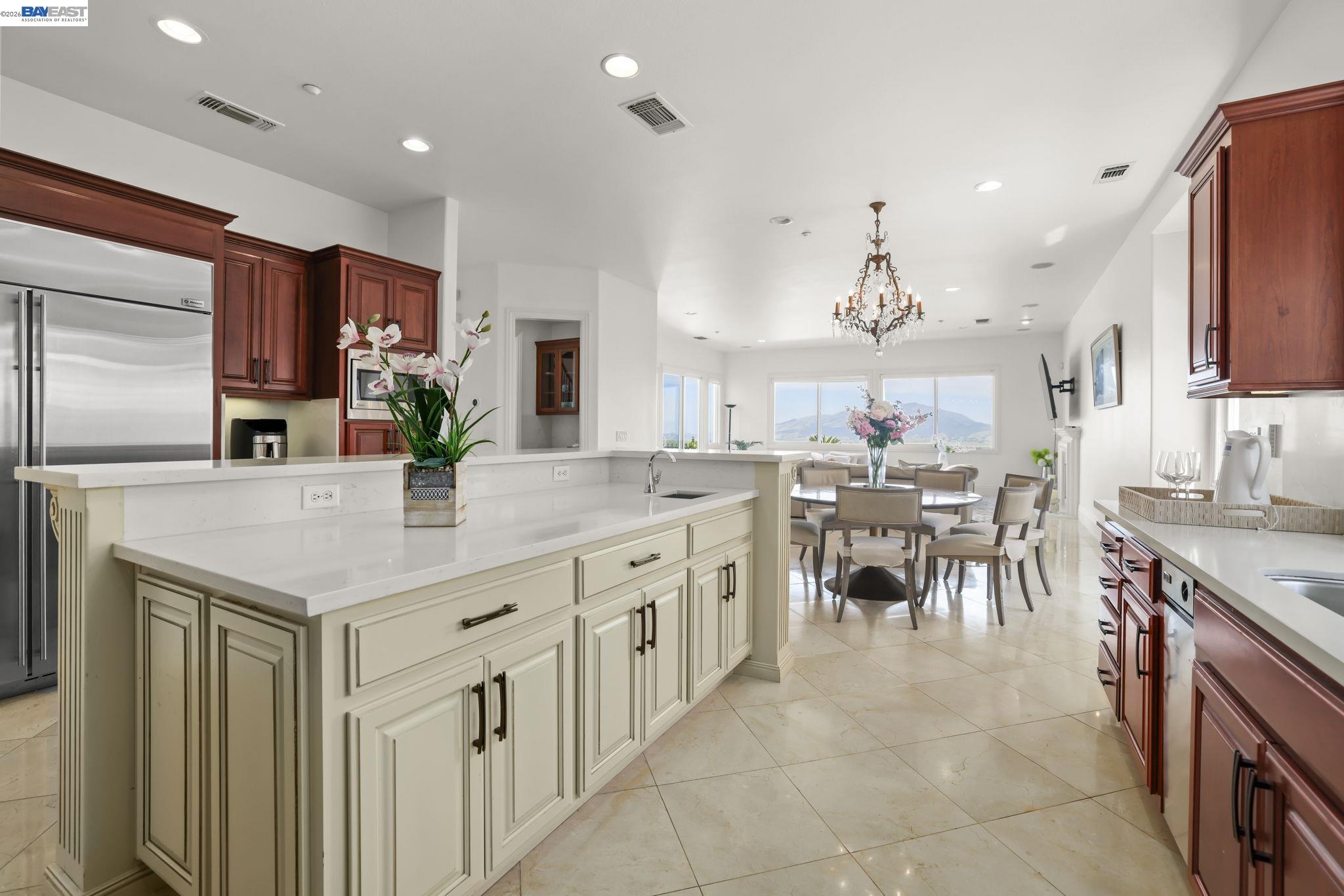 950 Winsford Court San Ramon, CA 94583 - Photo 27 of 68 a kitchen with stainless steel appliances kitchen island granite countertop a table chairs sink and cabinets