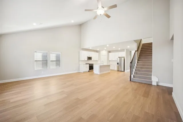 a view of a kitchen with a sink and a refrigerator