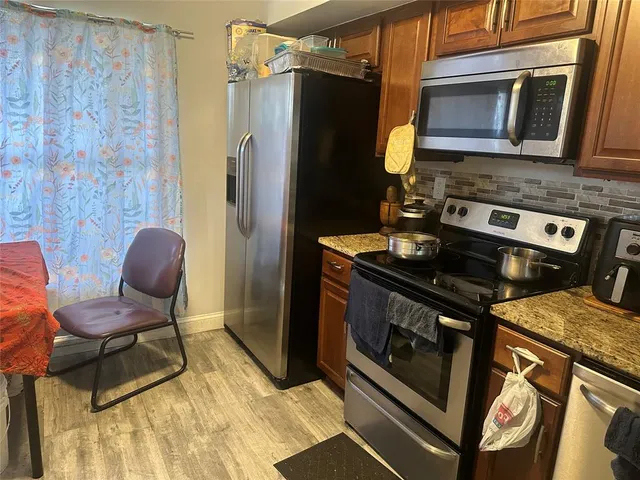 a stove top oven sitting inside of a kitchen