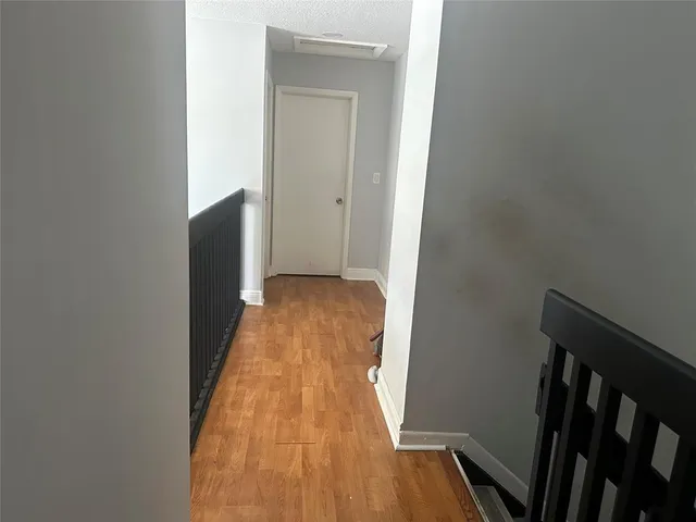 a view of hallway with wooden floor