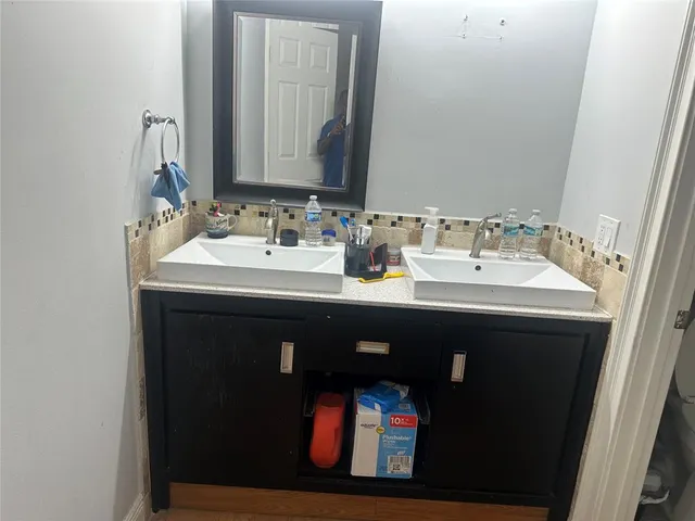 a bathroom with a sink and a mirror