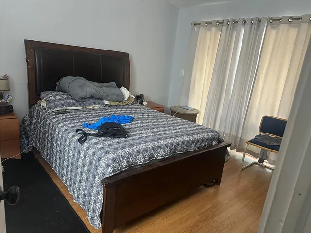 a bedroom with a bed and a mirror